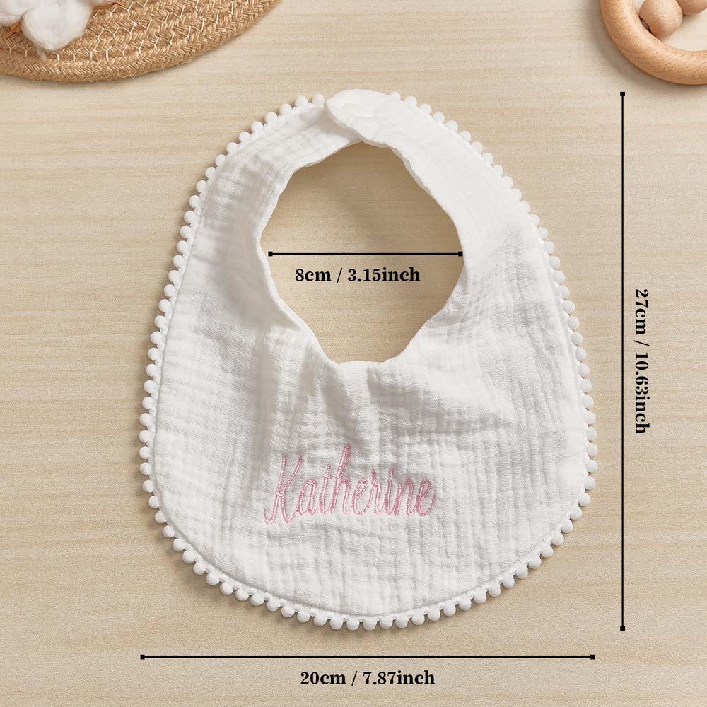 Flat-lay personalised baby bib showing soft texture and custom embroidery — bespoke newborn present