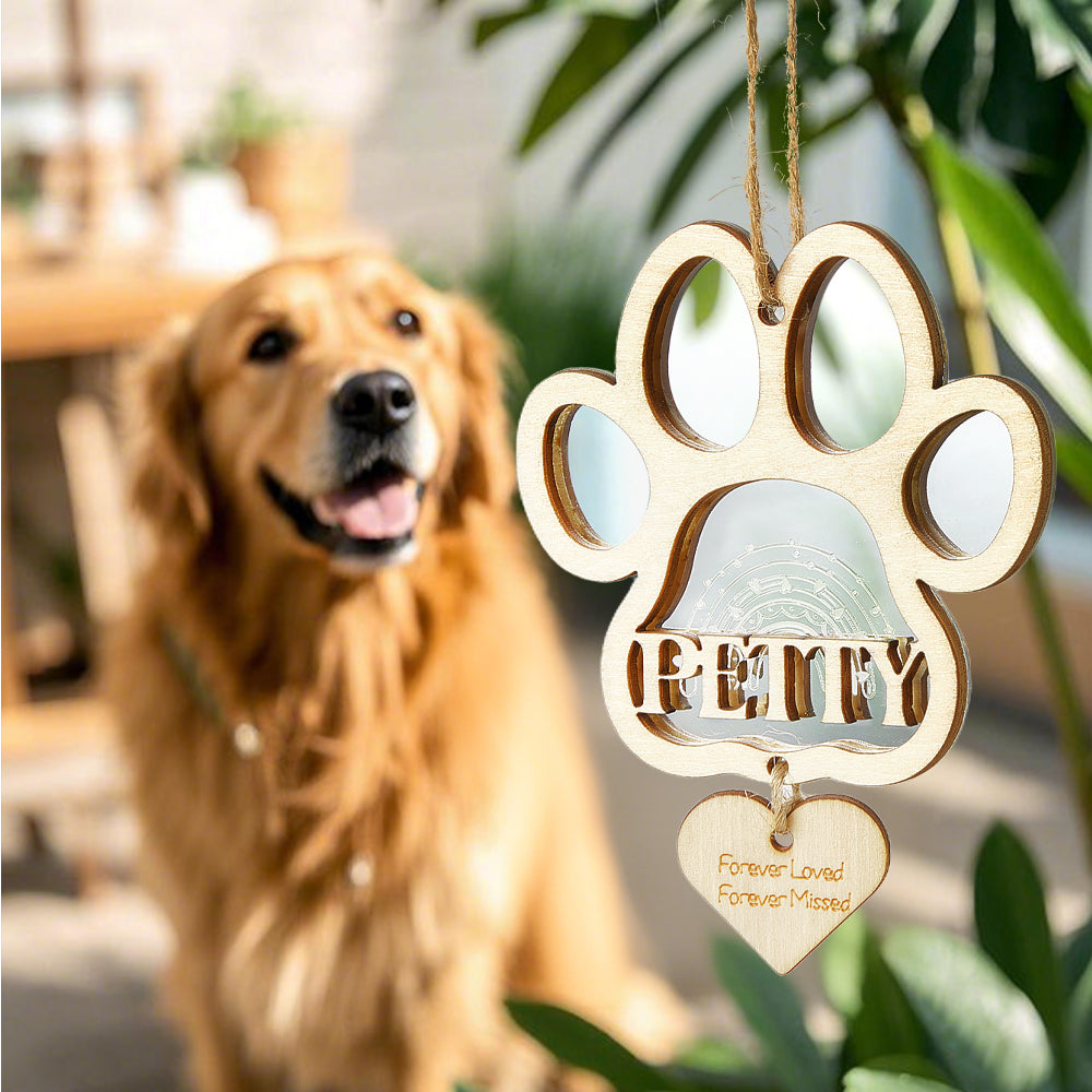 Personalised dog paw memorial ornament hanging on a decorated Christmas tree, bespoke pet loss gift for grieving pet owners