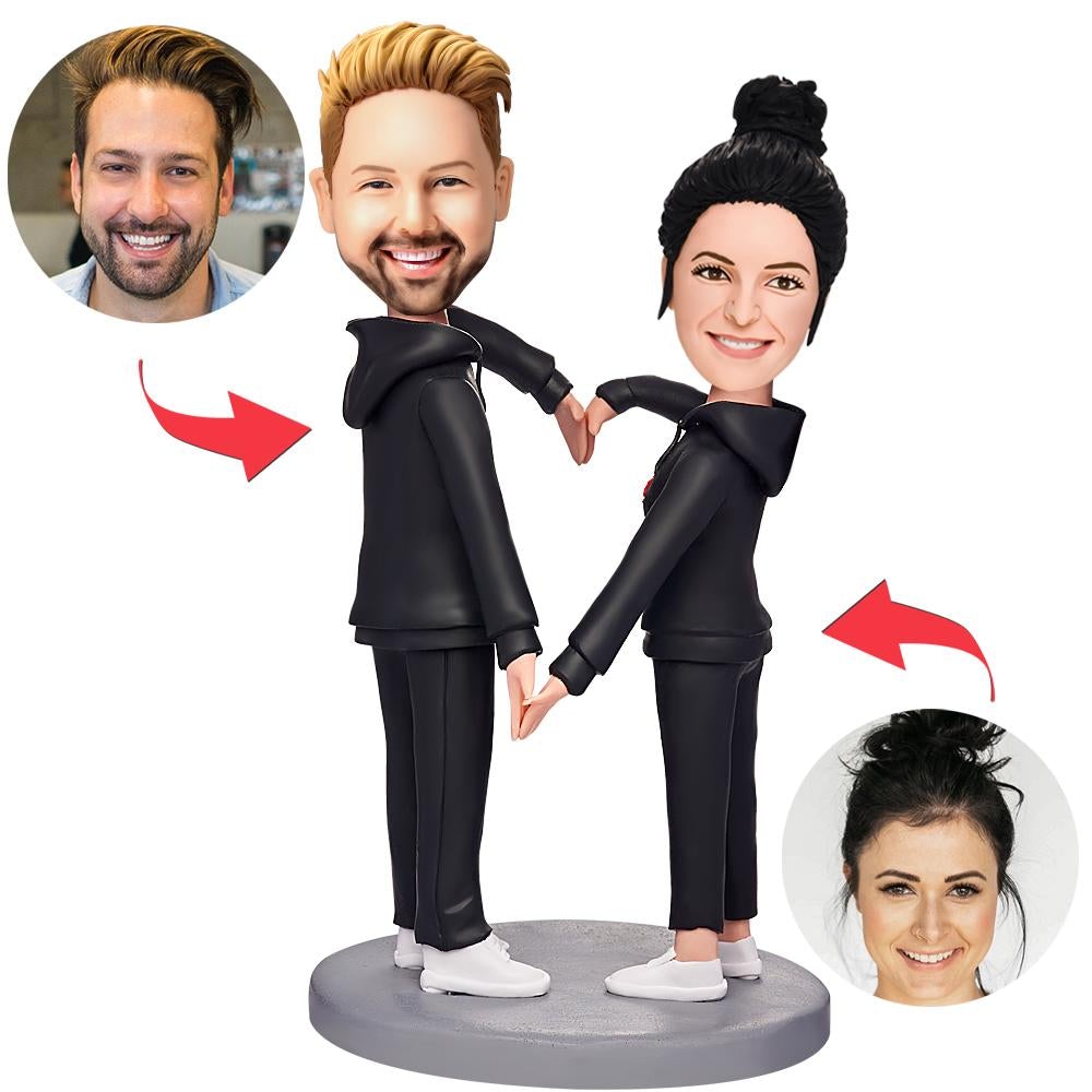 Personalised black suit couple bobbleheads in heart pose with custom photo heads and engraved base, handcrafted polymer clay personalised wedding keepsake