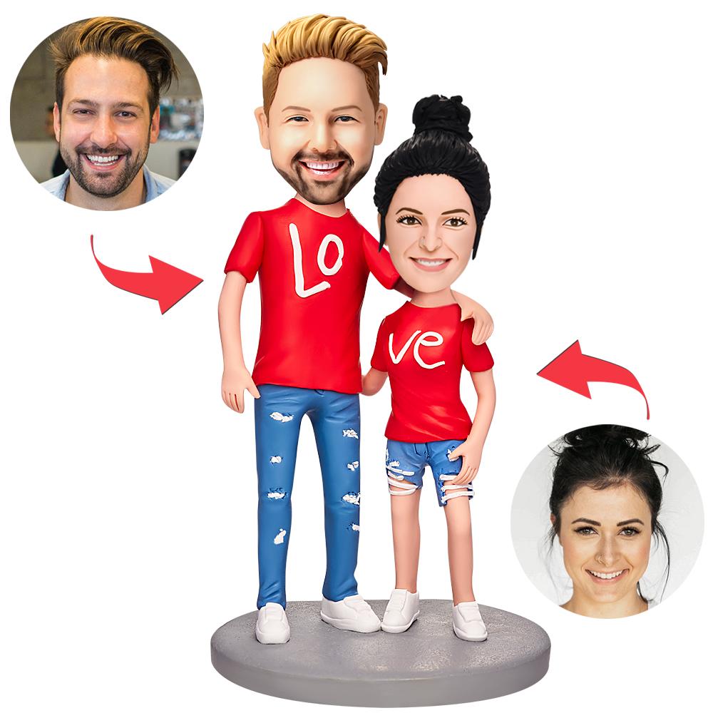 Custom couple bobbleheads — personalised love couple bobbleheads wearing personalised couple shirts, handcrafted polymer clay bobbleheads with photo-matched heads and engraved keepsake base