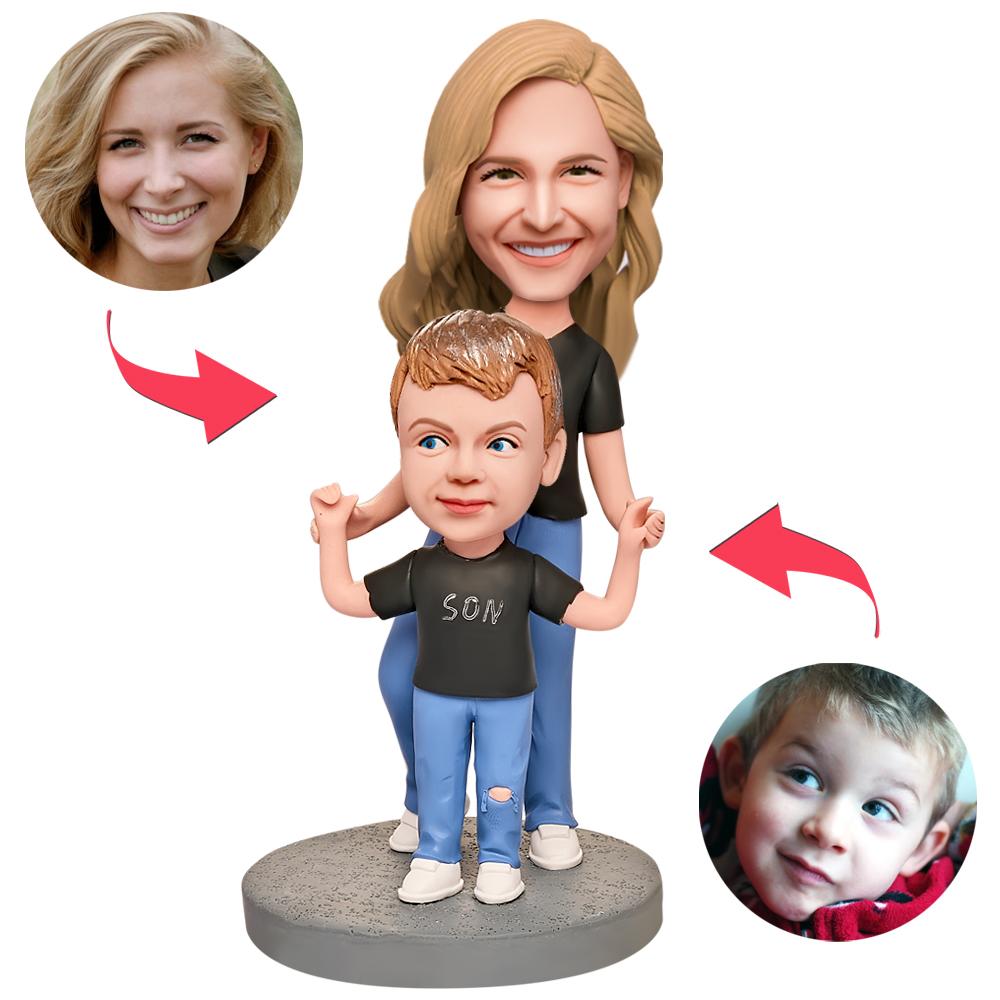 Personalised mother and son bobblehead in black shirts — polymer‑clay custom heads with engraved text plate, bespoke keepsake gift