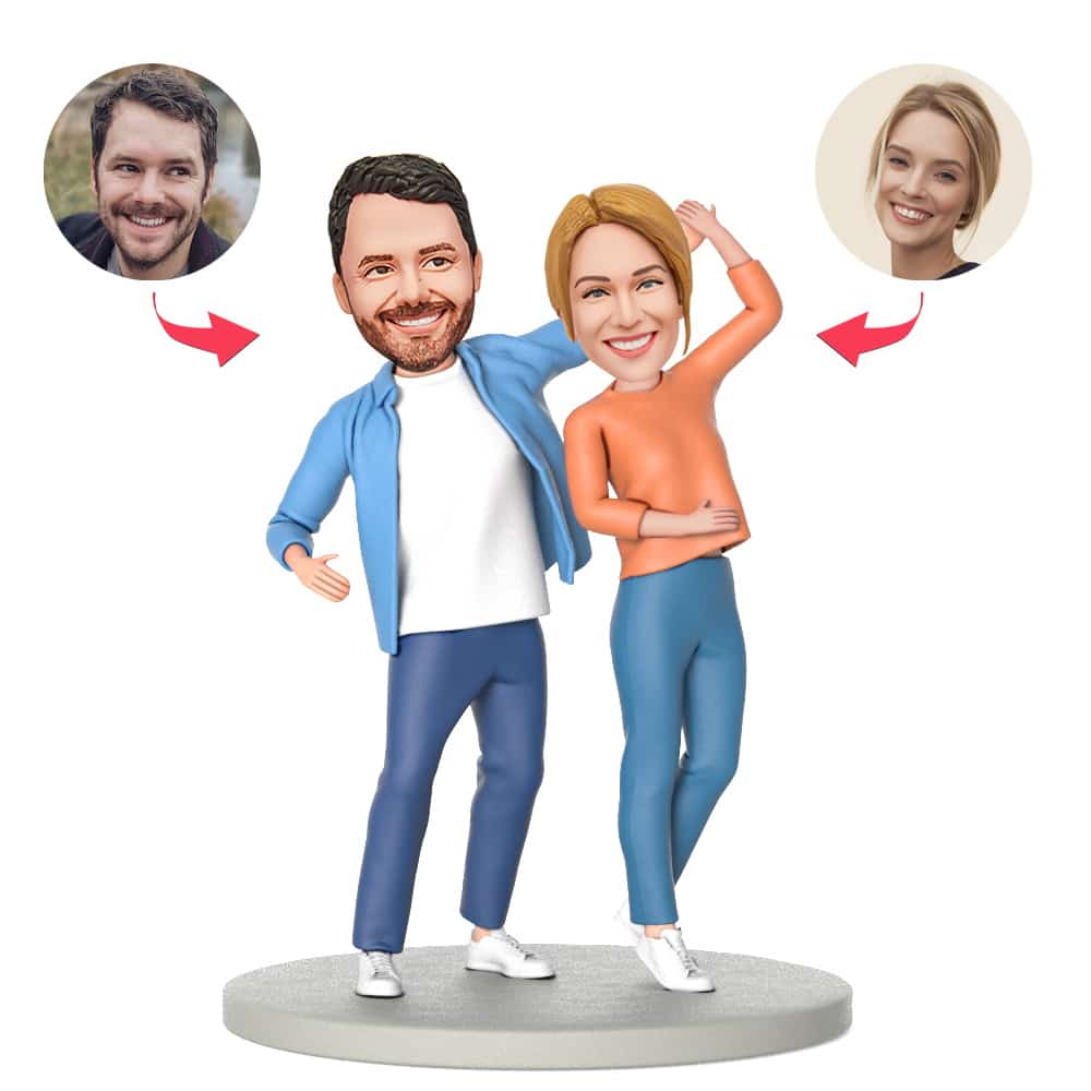 Personalised couple holding hands dancing bobblehead in polymer clay with customised heads and engraved text on the base, ideal personalised couple bobblehead gift