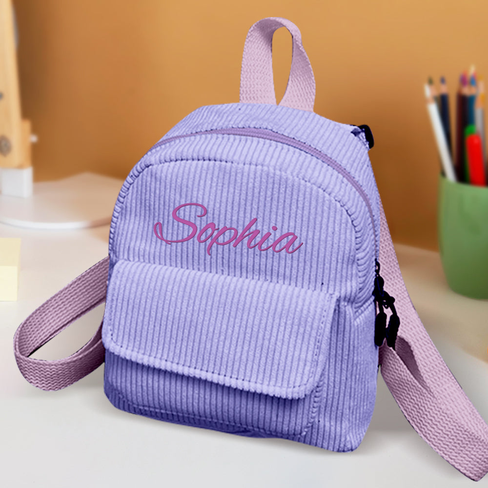 Mini corduroy backpack open with snacks and small water bottle inside – roomy personalised compartment for kids