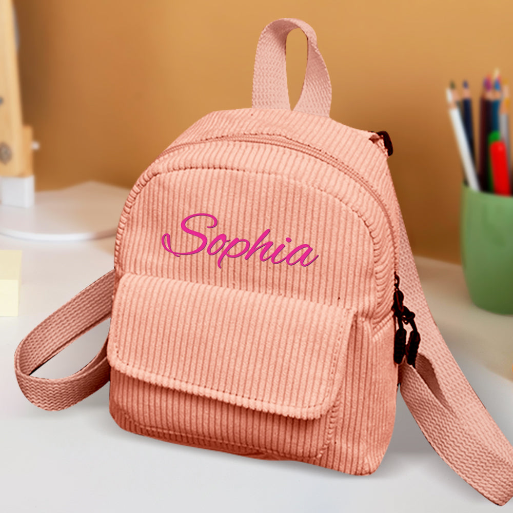 Child wearing a personalised mini corduroy backpack with embroidered name at a playdate – easy-to-identify school bag