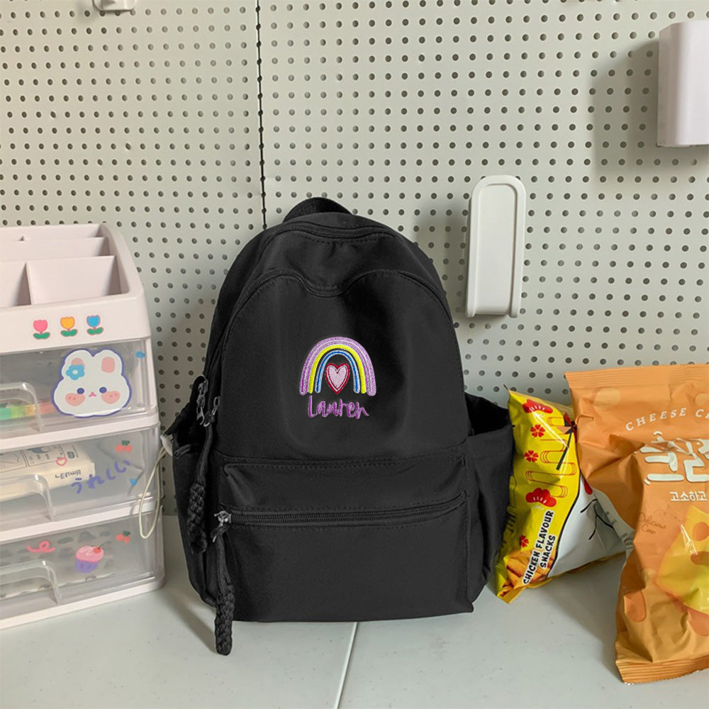 Close-up of embroidered name and vivid rainbow stitching on personalised backpack, highlighting high-quality embroidery and durable fabric