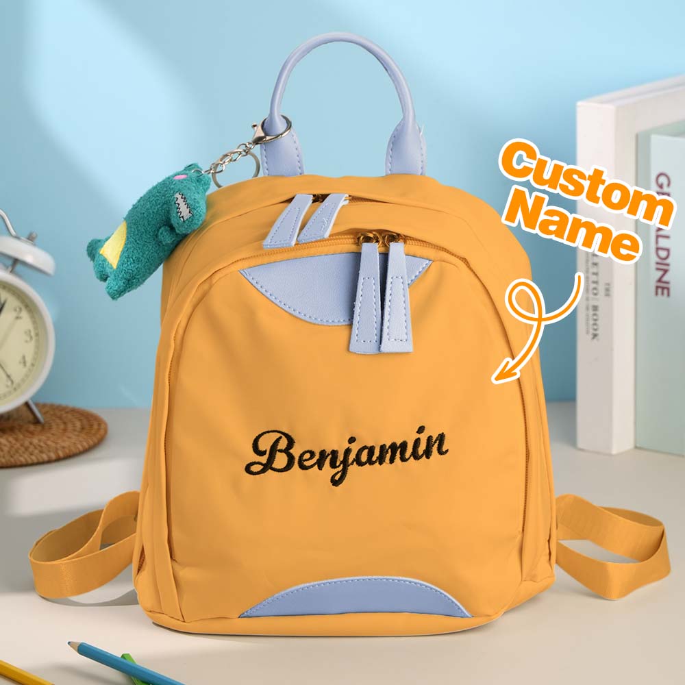 Mini personalised school bag worn by child – lightweight custom school backpack with padded straps and stitched name for kids