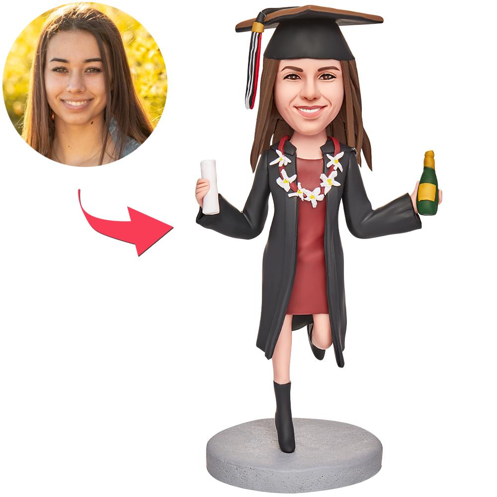 Personalised polymer clay graduation bobblehead of a girl holding a teddy bear and certificate with engraved text on the base – custom graduation gift