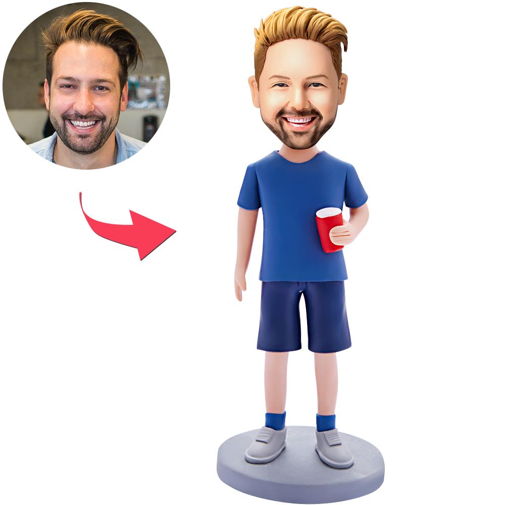 Personalised bobblehead of a man holding a water glass — handcrafted polymer clay figure with customised head from your photo and engraved text on the base