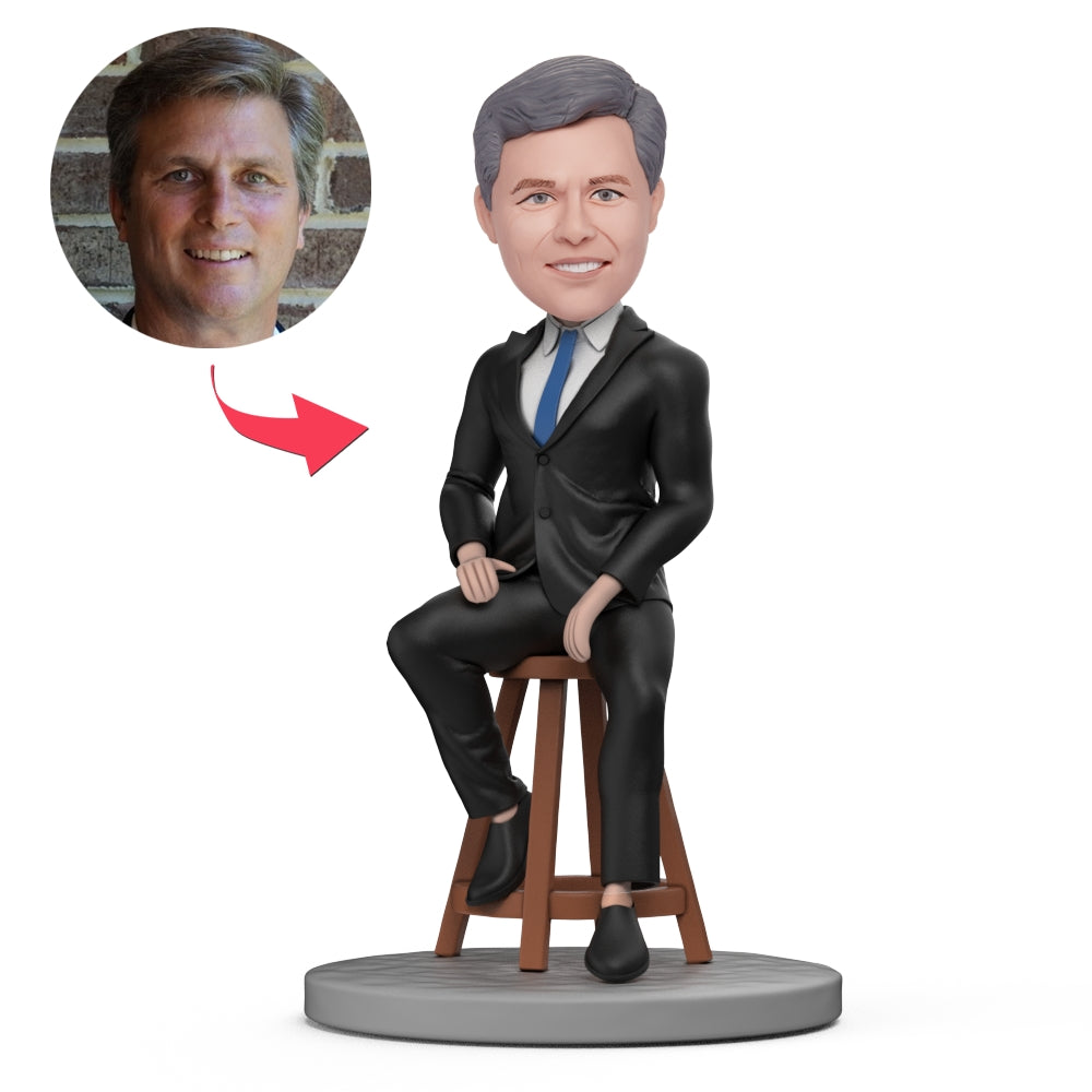 Personalised male boss bobblehead in black suit, handcrafted polymer clay figurine with customised head likeness and engraved text on the base — personalised bobblehead desk keepsake