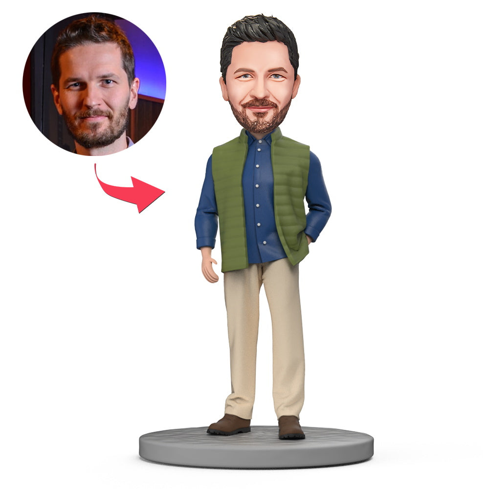 Front view of handcrafted polymer clay personalised bobblehead in blue shirt and green vest with engraved text on the base, ideal personalised gift