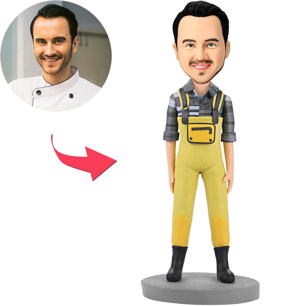 Personalised polymer clay bobblehead of a fashion man in yellow bib pants with customisable head and engraved text option, ideal personalised desk gift