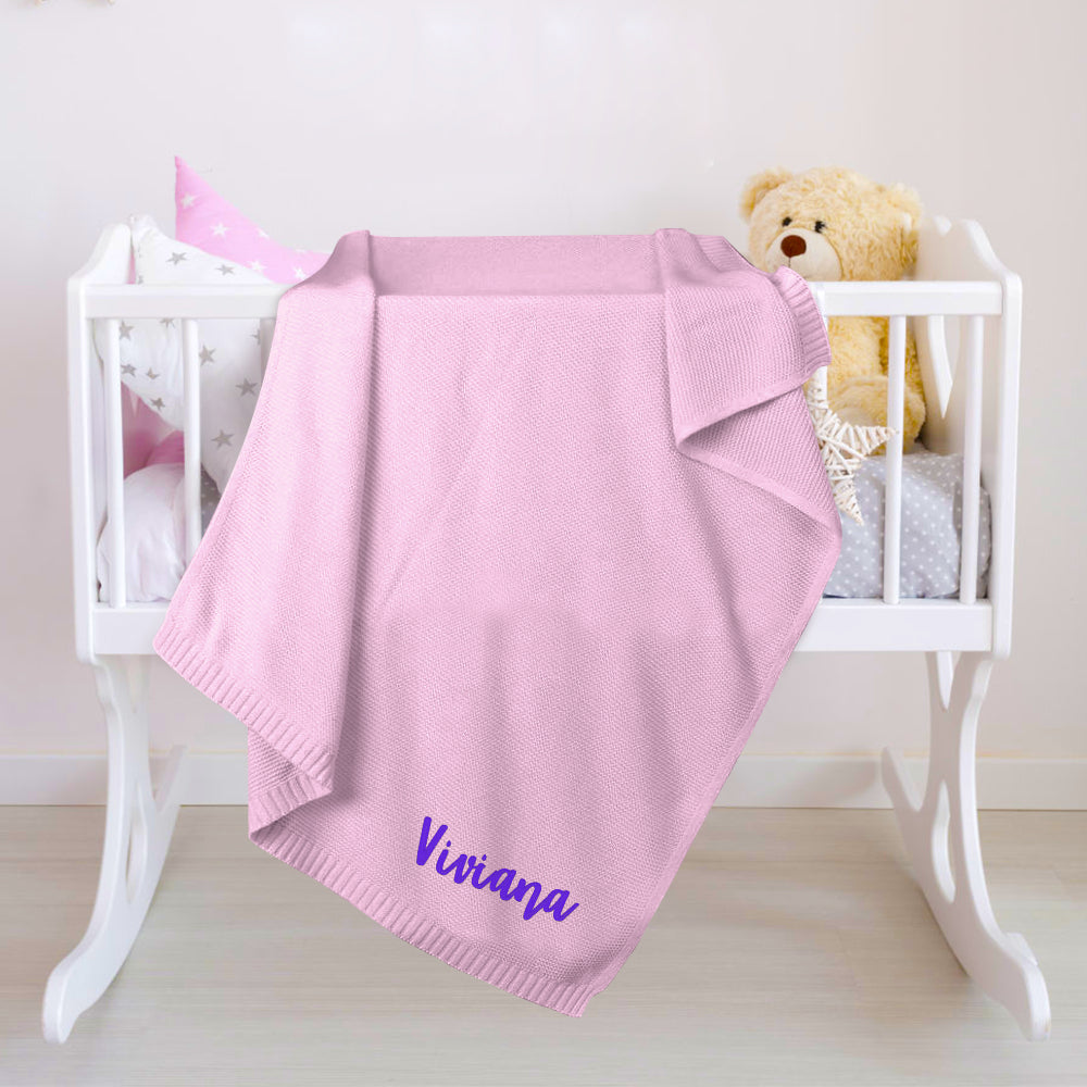 Close-up of knitted fabric texture on the personalised baby blanket.