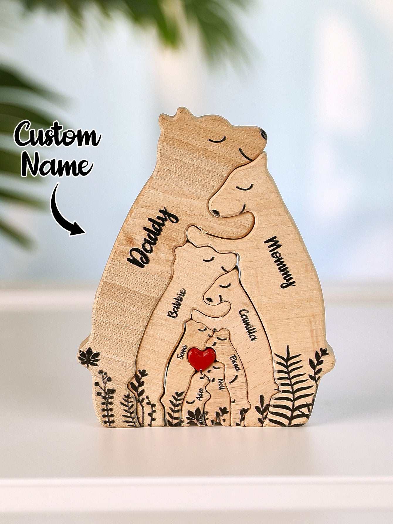 Top-down styled photo of personalised wooden heart bear puzzle on shelf – engraved family names for home display