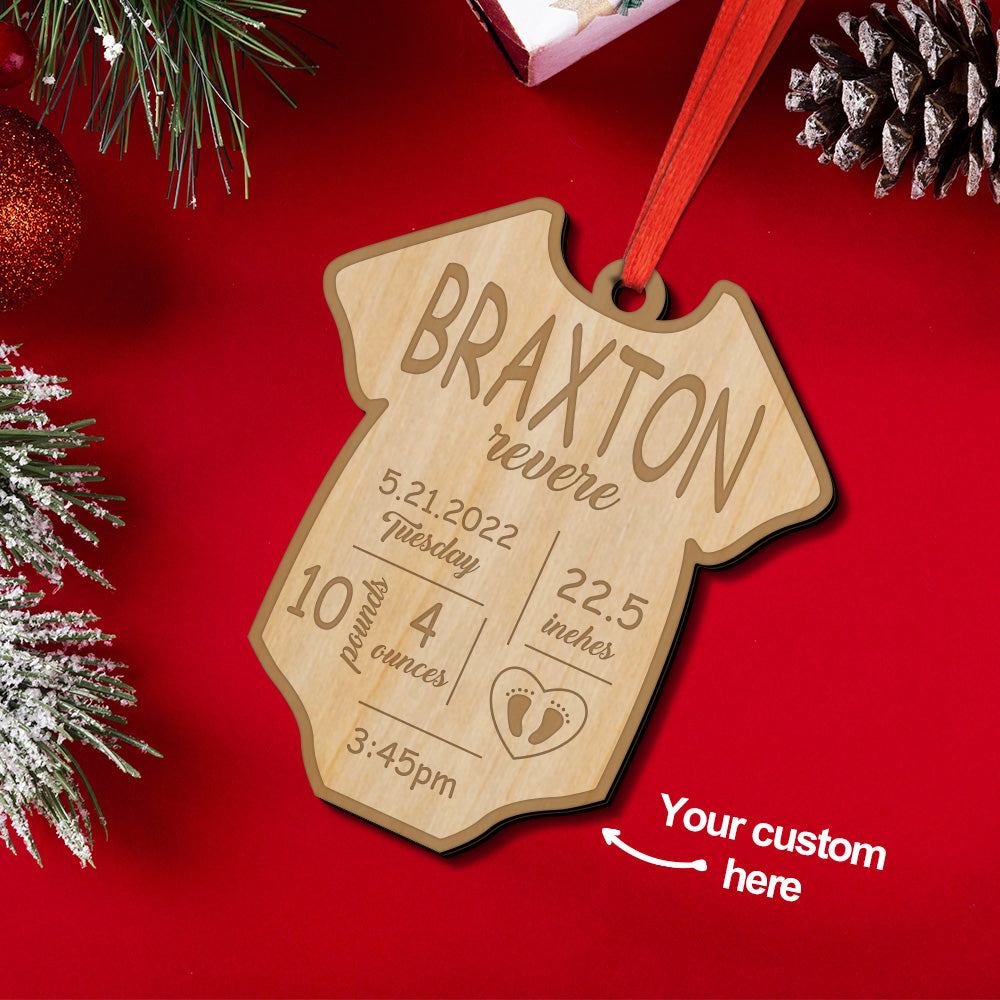 Personalised baby birth ornament — engraved wooden bauble with name and birth details hanging on a Christmas tree, a timeless wooden first Christmas keepsake and custom birth stats decoration