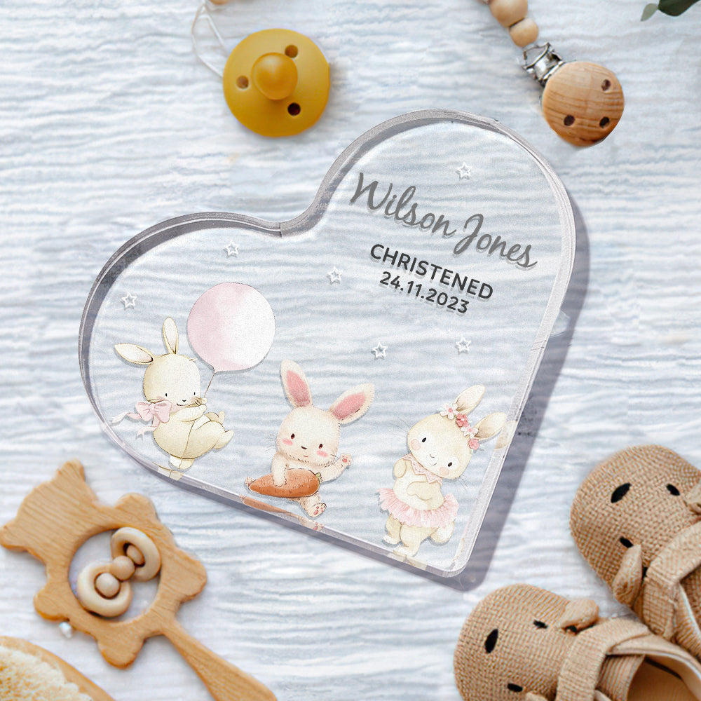Close-up of animal decorations and precise engraving on clear acrylic heart — ideal personalised christening present