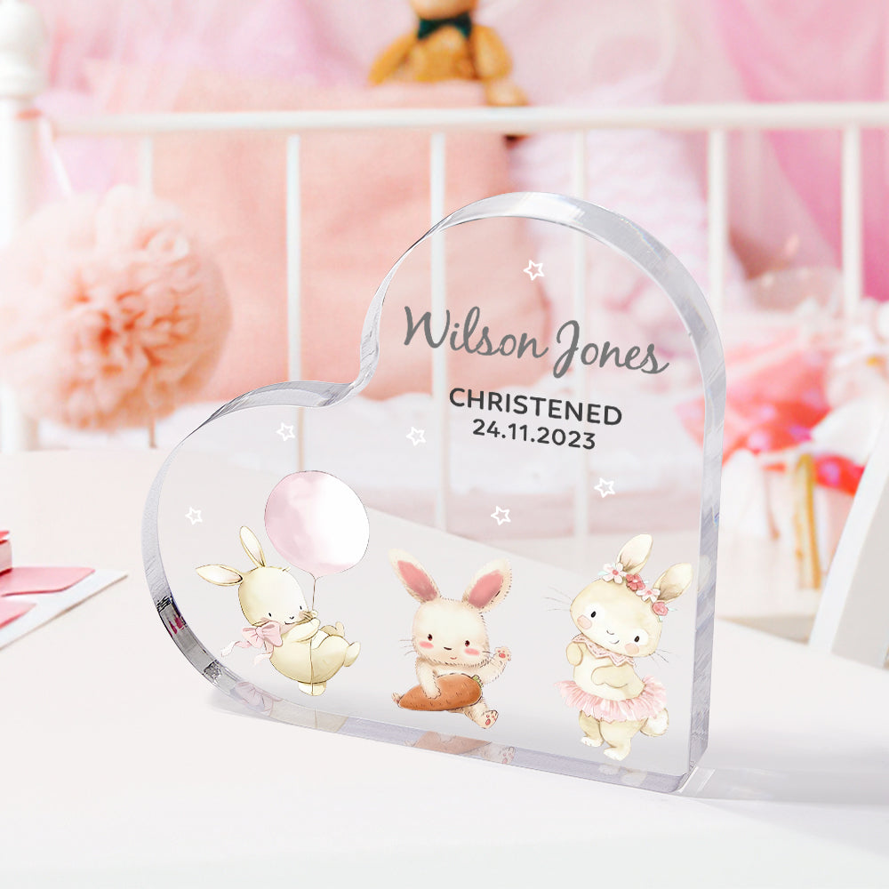 Styled scene of personalised engraved heart ornament as a new baby gift — name and date engraving, gender‑neutral design