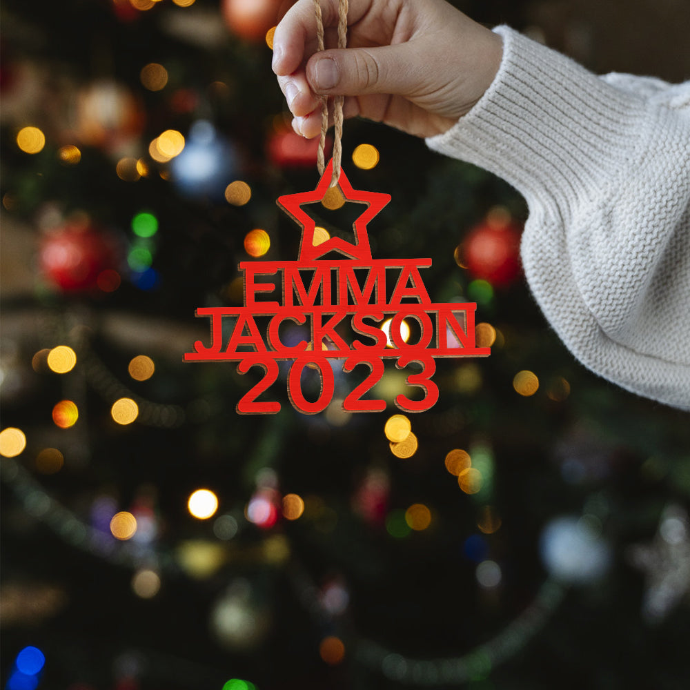 Festive tree aglow with personalised wooden Christmas tree ornaments, children spotting their custom name decorations and creating lasting holiday memories