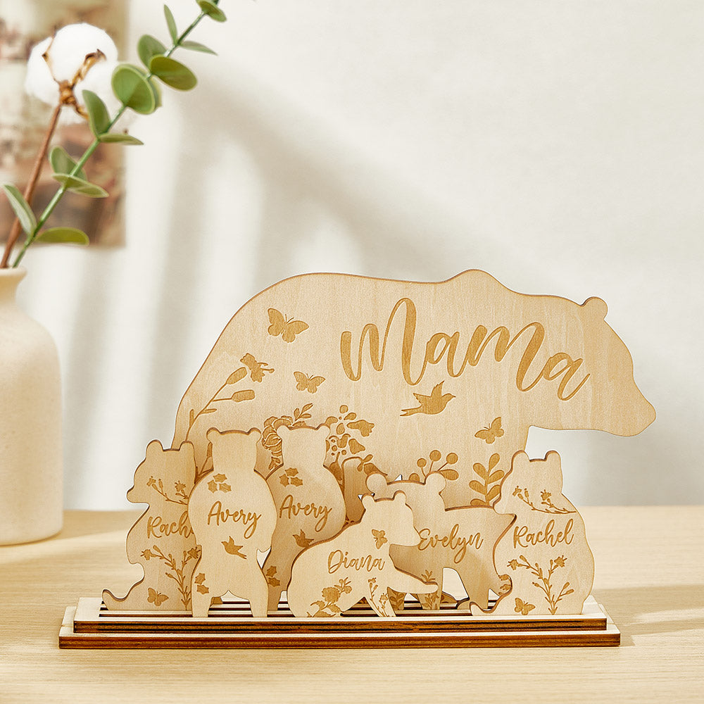 Multiple personalised mama bear with cubs decorations with different name combinations displayed as bespoke engraved gifts for mothers