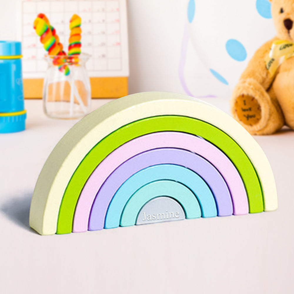 Montessori wooden nesting puzzle arranged as rainbow tunnel blocks in muted earth colours, eco friendly toy for nursery décor