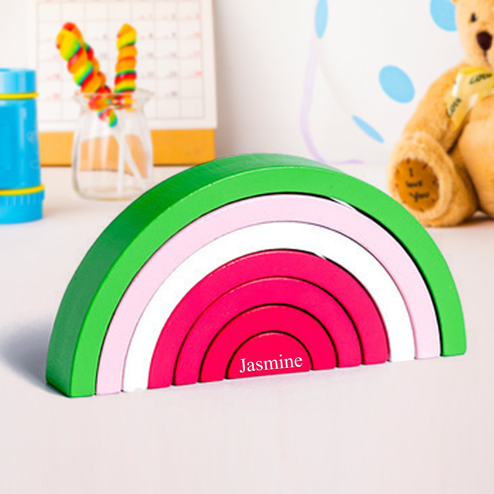 Close-up of rainbow tunnel blocks showing smooth finish and natural wood grain on this eco friendly wooden stacking toy