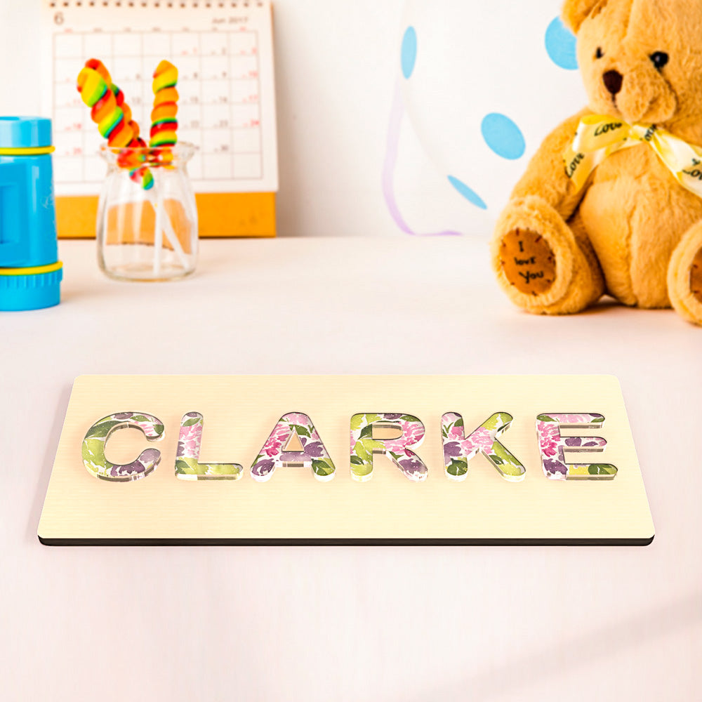 Personalised name puzzle presented as a bespoke acrylic Montessori baby gift — ideal for birthdays and baby showers