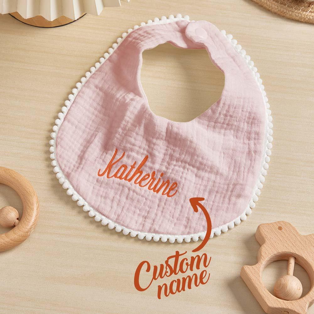 Lifestyle view of a personalised embroidered baby bib among baby accessories — sentimental and practical newborn keepsake