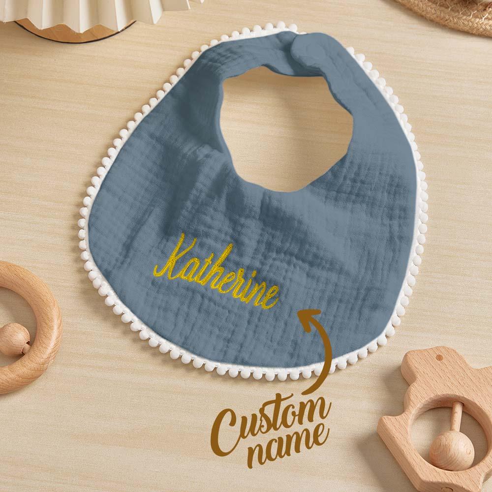 Stack of personalised embroidered baby bibs showing colourways and cotton texture — ideal personalised baby gift set