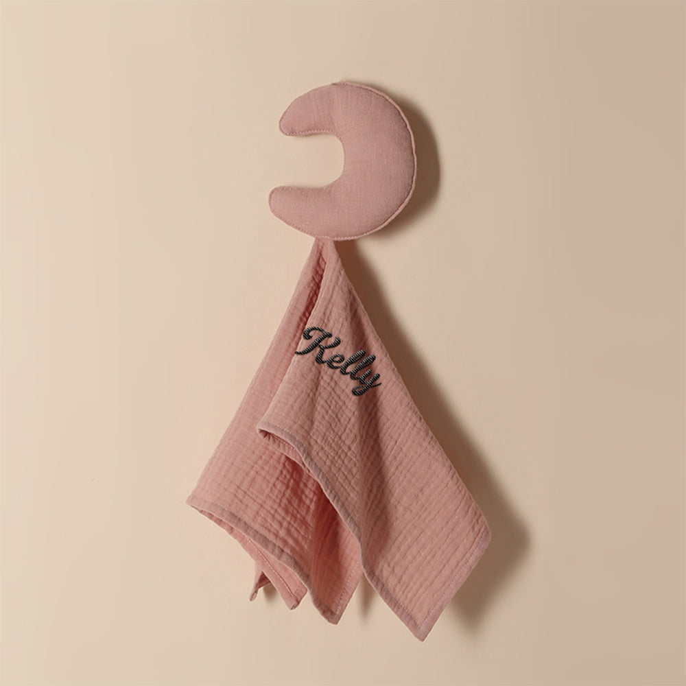 Baby towel personalised with embroidered name shown beside soft toys, premium cotton comforter for cuddles and sleep