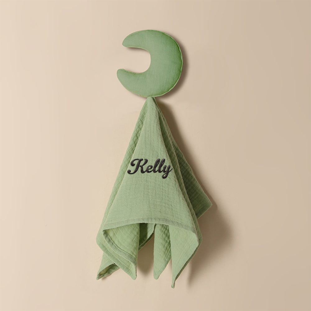 Personalised baby towel photographed with measuring guide to show 15in x 15.75in size, embroidered name detail included