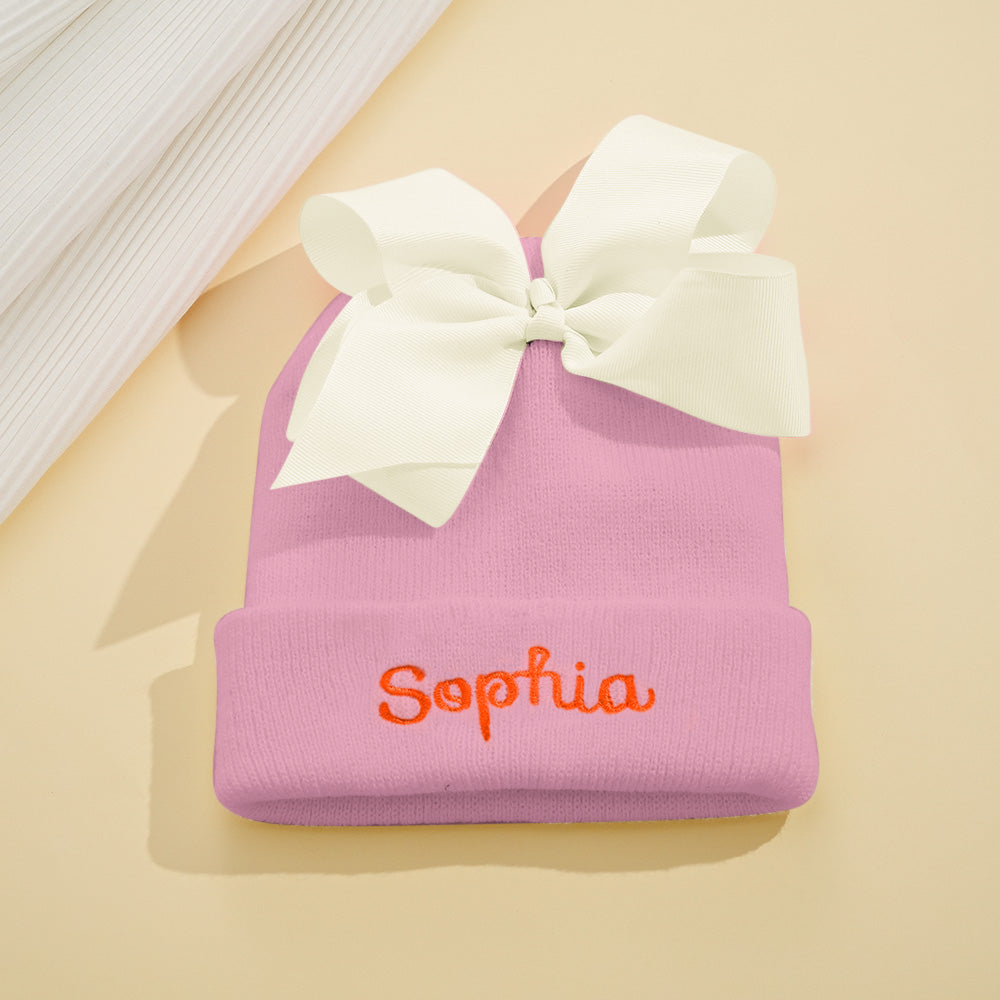 Range of personalised knitted baby hats in assorted colours — ideal personalised baby shower or birthday gift