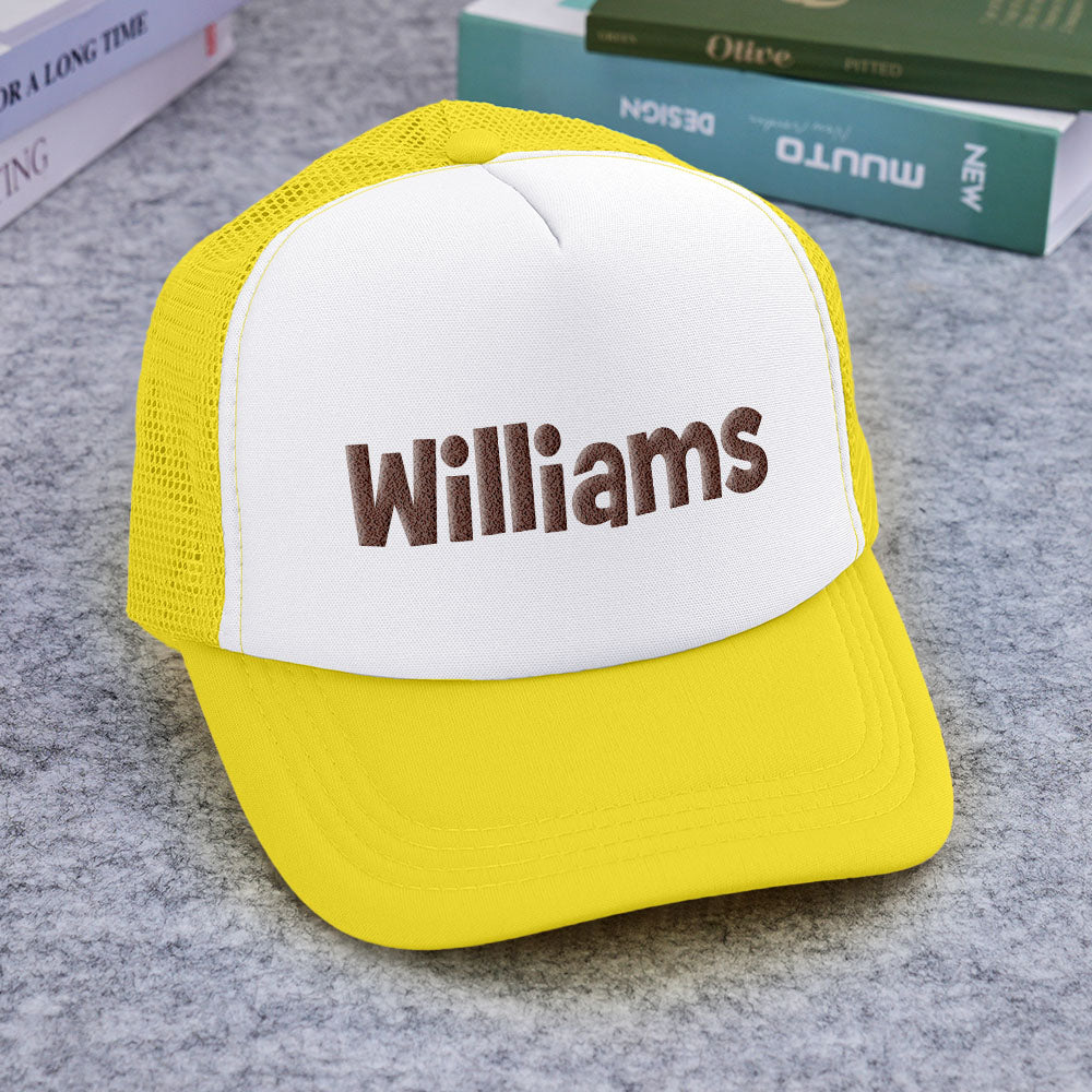 Flat display of multiple Custom Name Foam Trucker Caps showing personalised name options and puff-print finishes