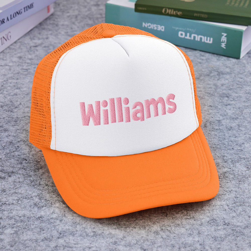 Model wearing personalised puff-print trucker hat in a casual setting — recommended personalised gift for adults and older children