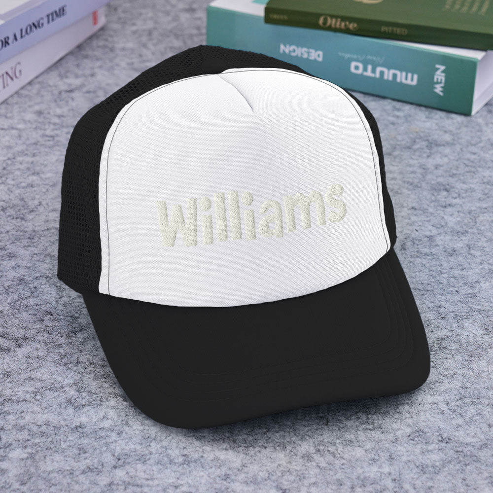 Lifestyle image showing a child and adult wearing personalised puff-print trucker hats — recommended personalised name gifts for families