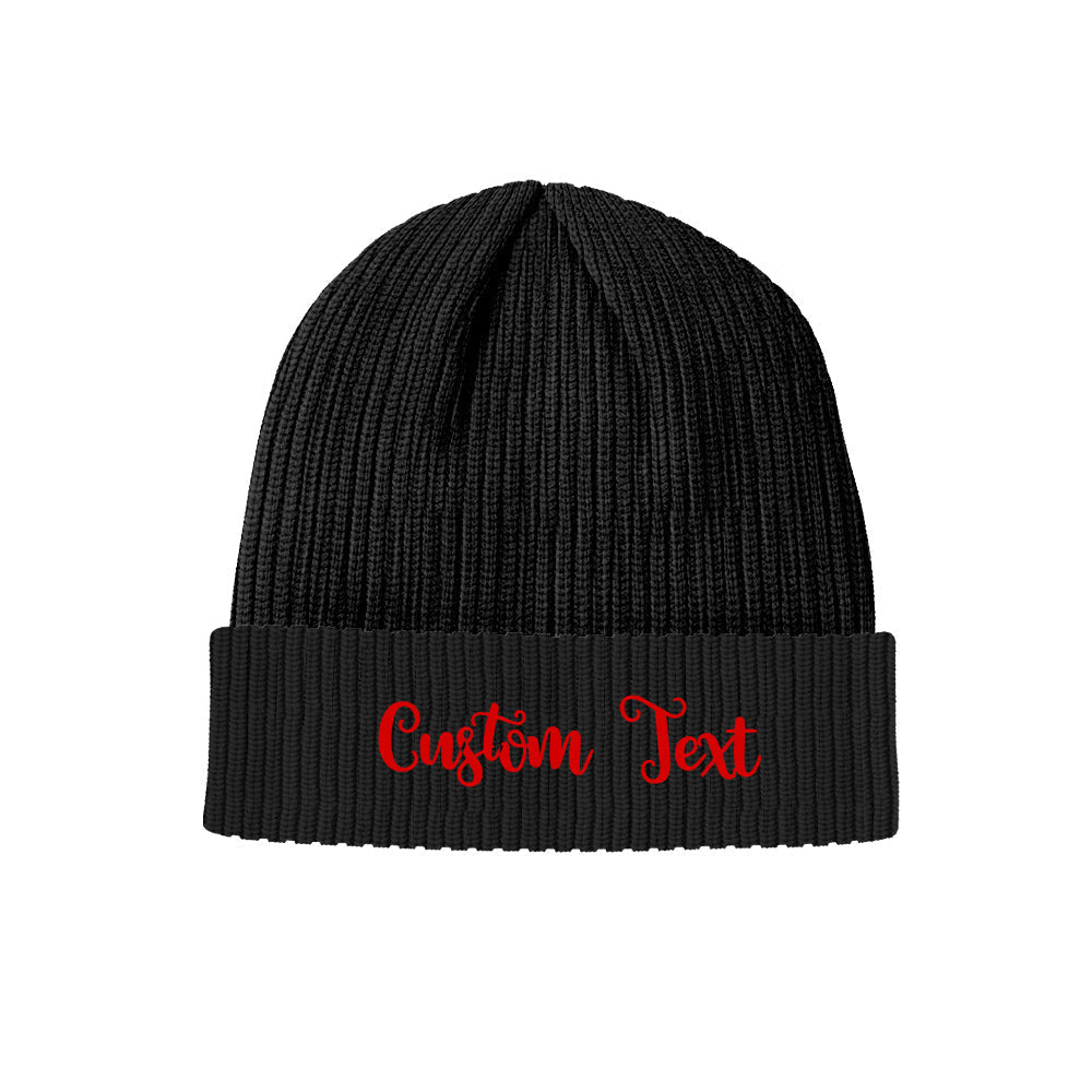 Close-up of the folded cuff of a personalised knitted hat displaying custom name text — soft elastic acrylic beanie for adults, perfect personalised gift