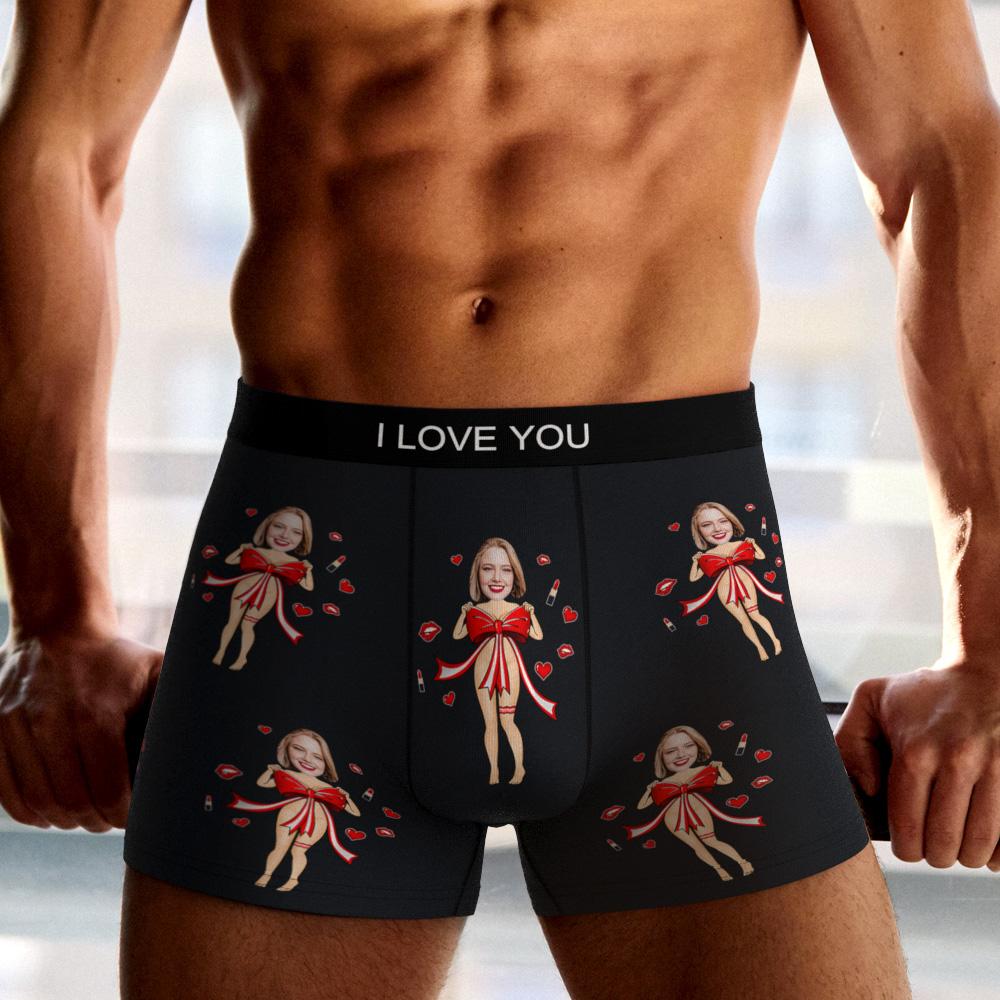 Flat-lay of personalised photo boxers (black) with red bow motif and vivid custom face print on polyester fleece