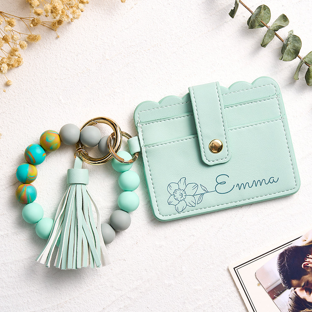 Model wearing the detachable beaded bracelet looped around wrist, demonstrating wearable compact personalised card wallet