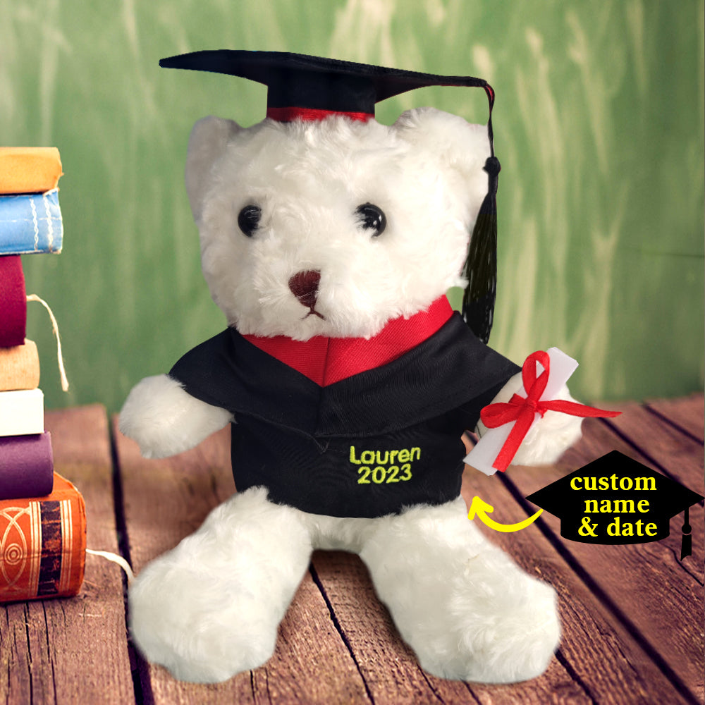 Graduate holding a personalised plush bear with custom robe and embroidered year, a sentimental graduation present for celebrations