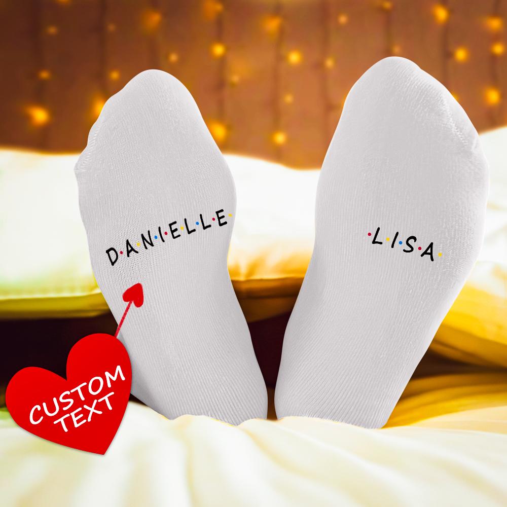 Pair of personalised Christmas socks with Santa pattern and engraved message on both soles – matching custom socks for couples and men