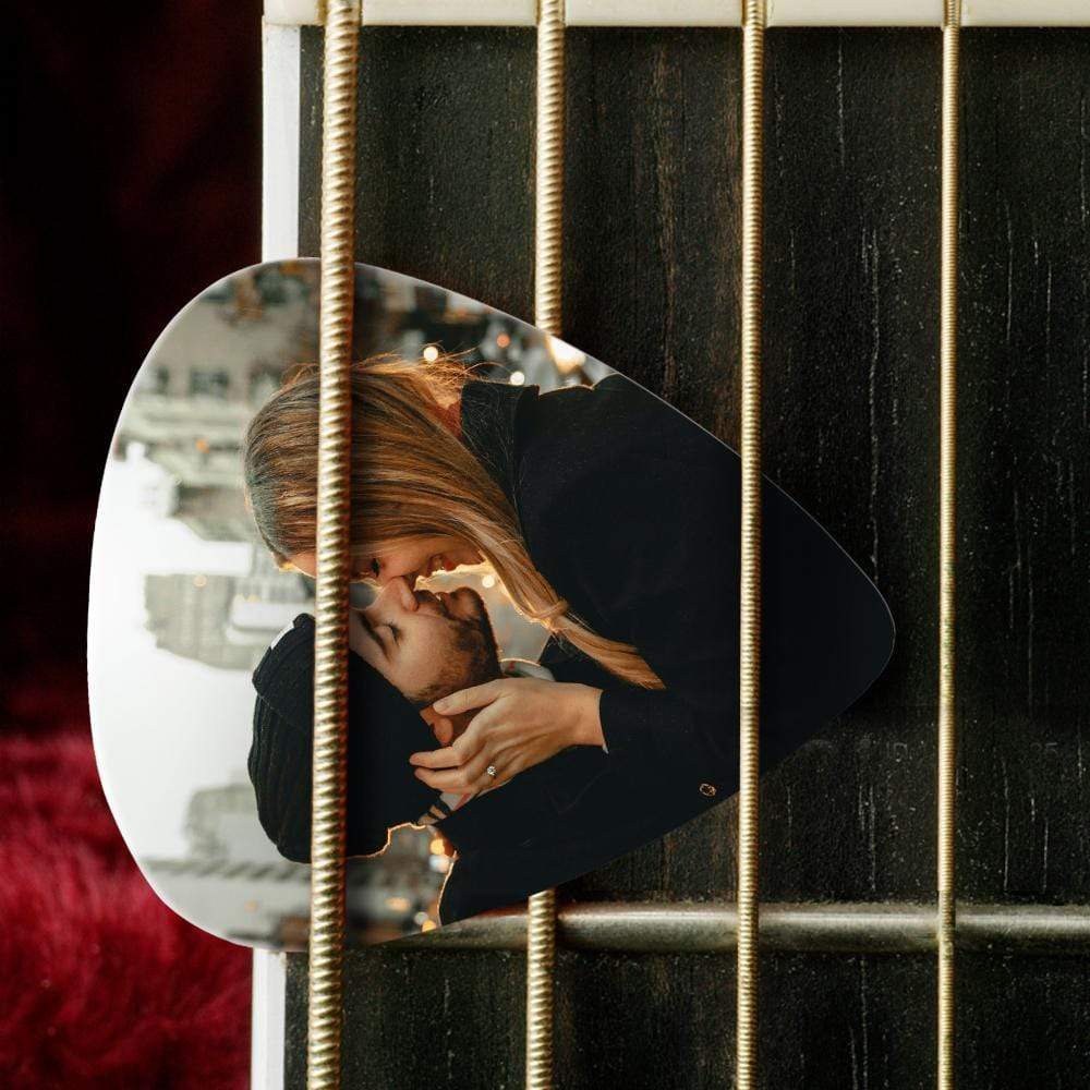Set of 12 personalised guitar picks fanned out showing different photo prints and custom text — ideal custom guitar picks gift