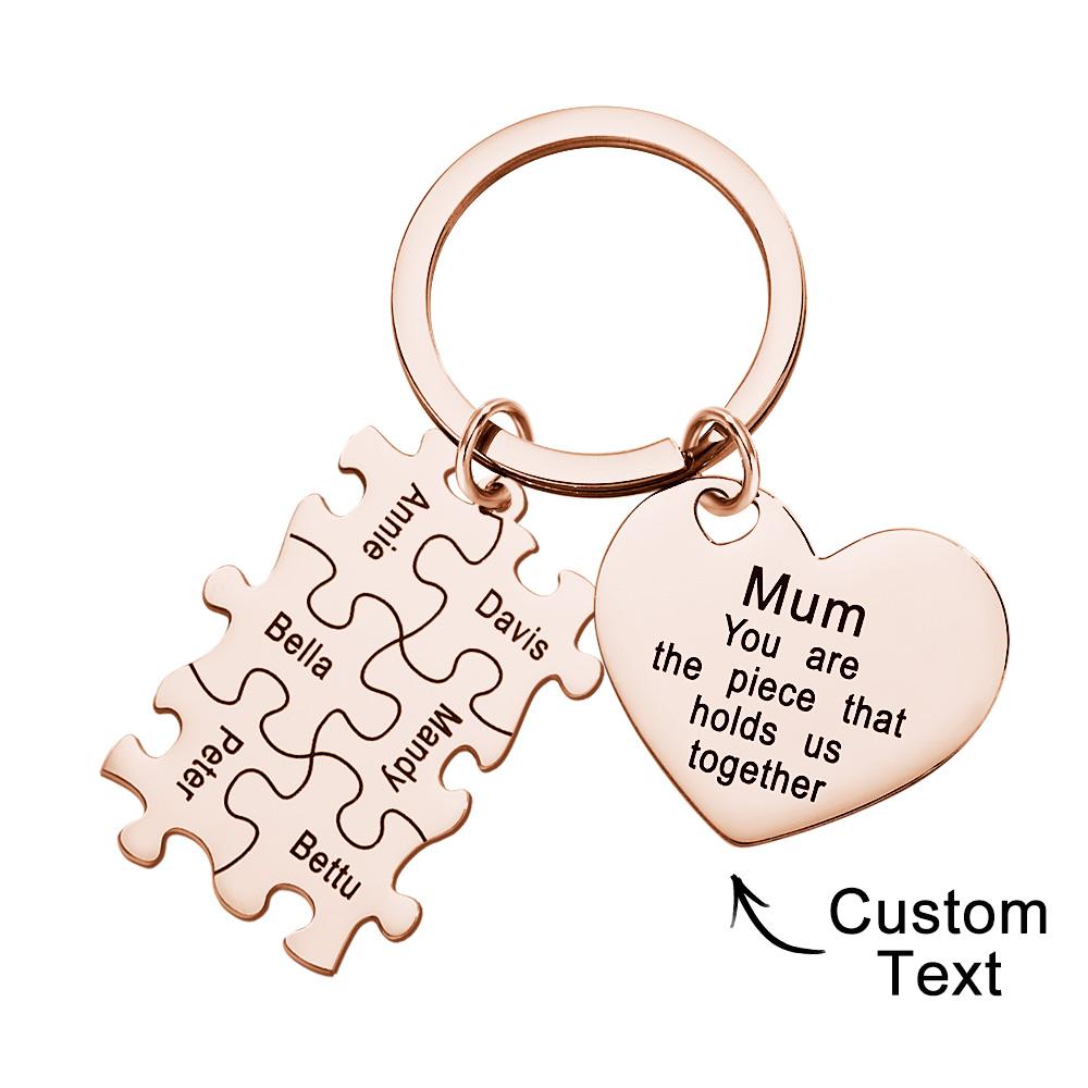 Two matching personalised puzzle heart pieces interlocked to form a whole heart — engraved names on a custom keyring pair