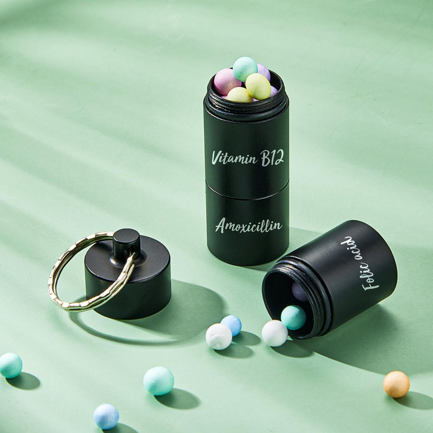 Three‑stack design shown separated to reveal individual compartments — personalised pill box keychain with custom engraving options