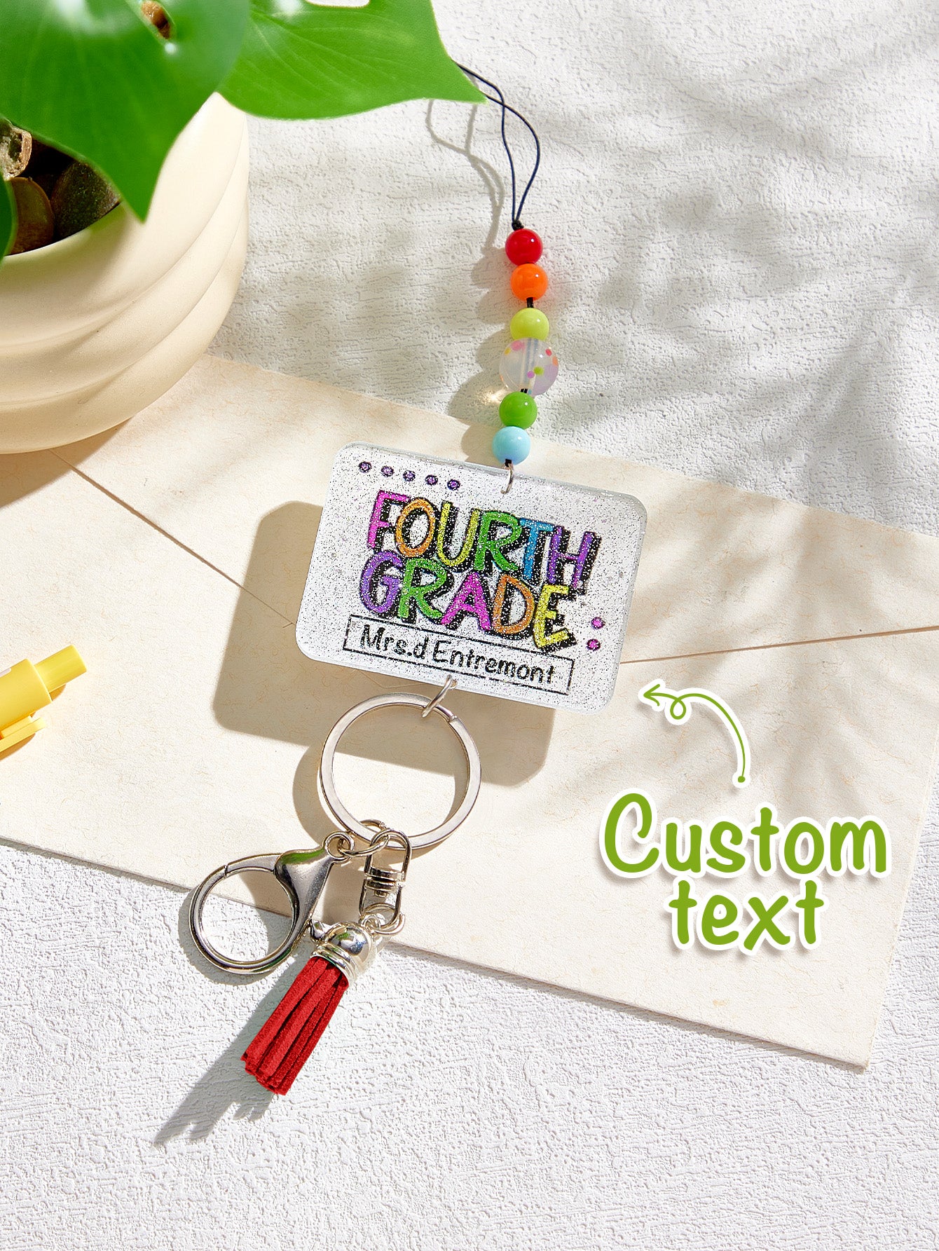 Close-up of acrylic bead shimmer and personalised name charm on glitter tassel lanyard — personalised glitter lanyard detail