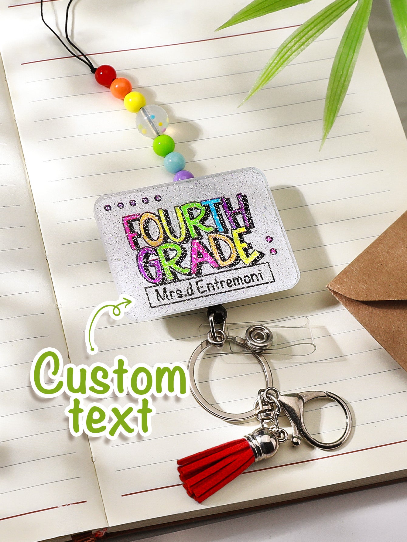 Close-up of tassel fibres and bead gloss on personalised glitter lanyard — decorative acrylic beaded detail