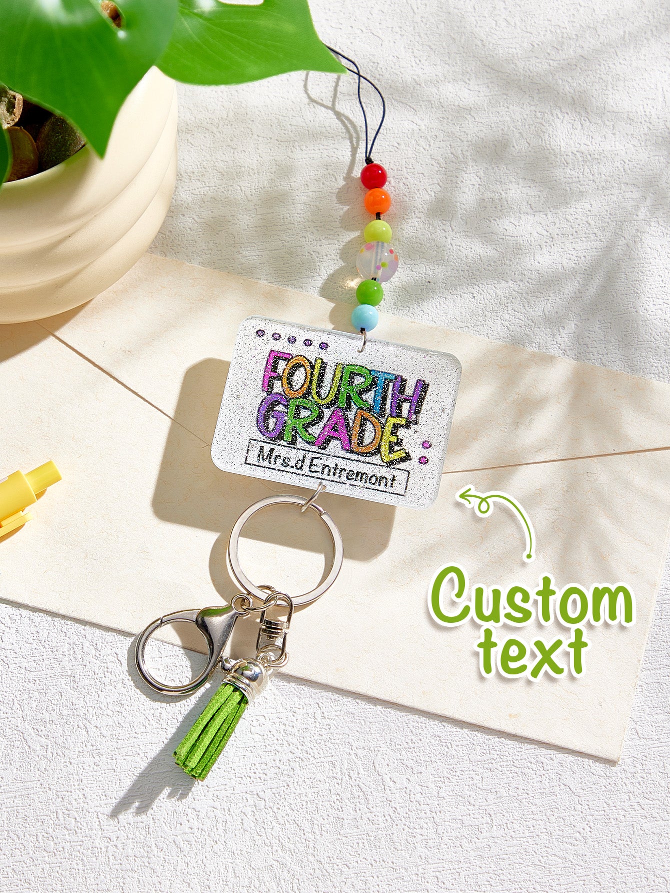Personalised glitter tassel lanyard shown with badge reel and keys — versatile acrylic beaded lanyard for staff and students