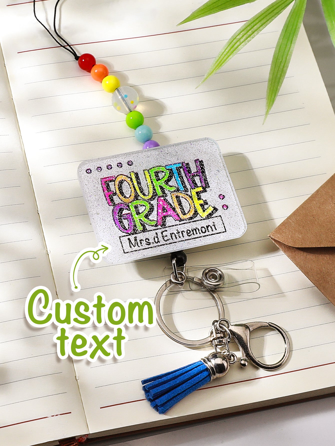 Styled desk shot showing lanyard beside stationery and ID card — personalised glitter lanyard for school life