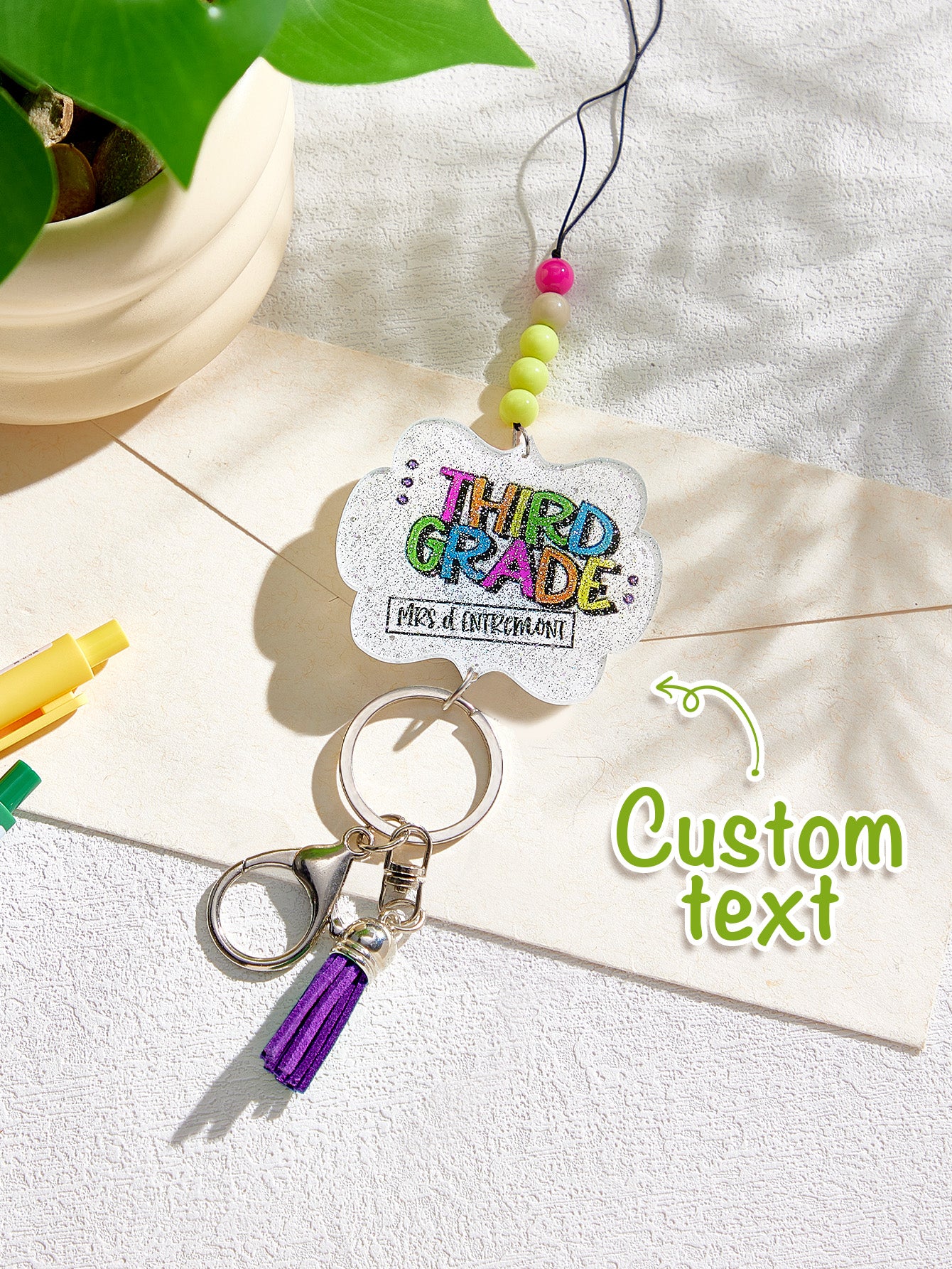 Macro shot of personalised name bead and glitter beads on tassel lanyard — perfect personalised teacher gift detail