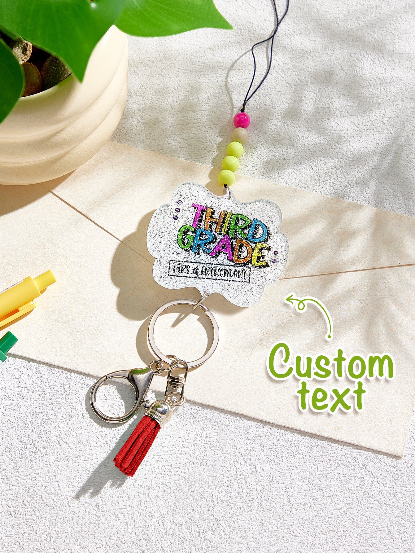 Tassel detail and bead gradient close-up on personalised acrylic beaded lanyard — glitter tassel lanyard feature