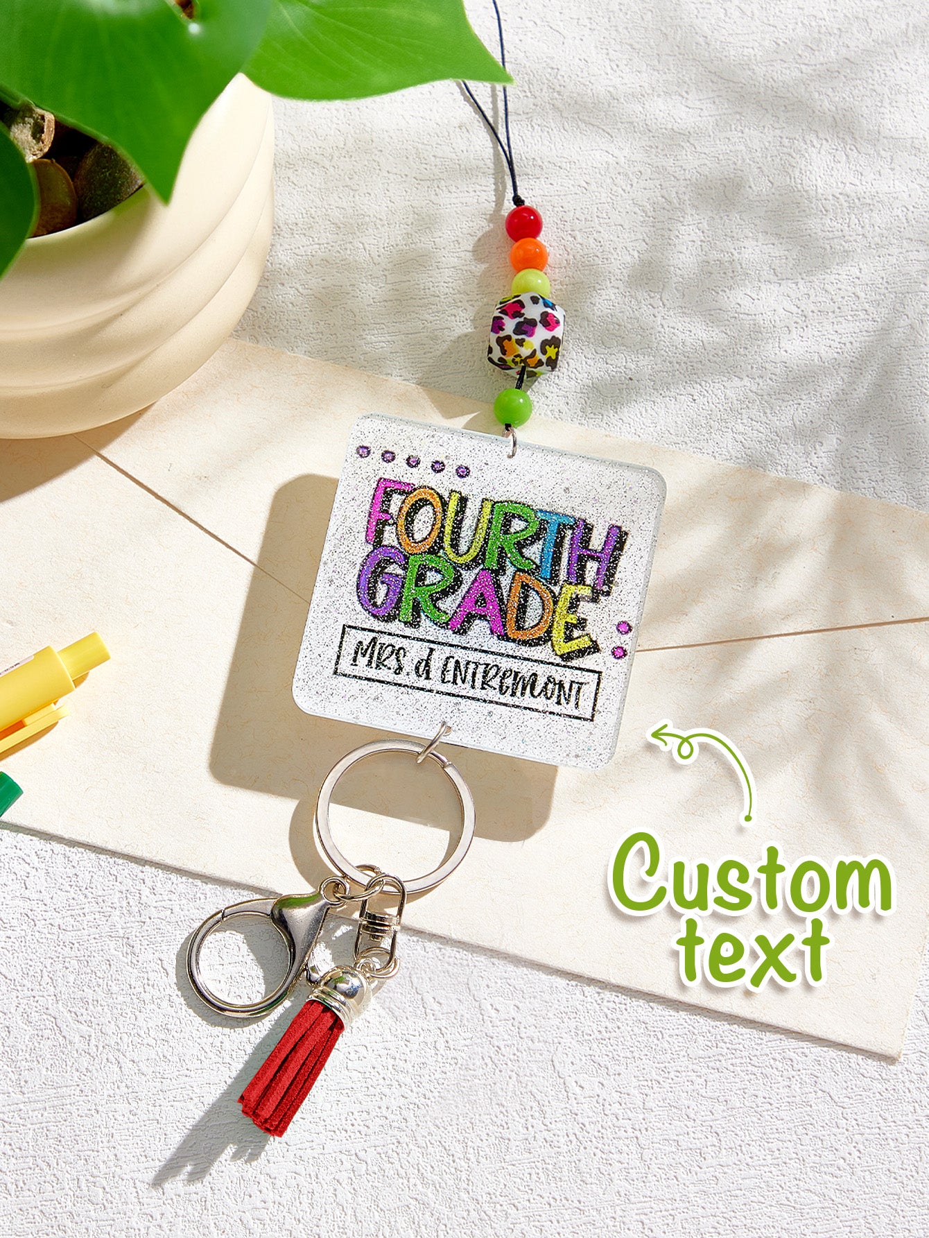 Personalised lanyard displayed with ID card and school supplies — teacher lanyard with name, practical and stylish