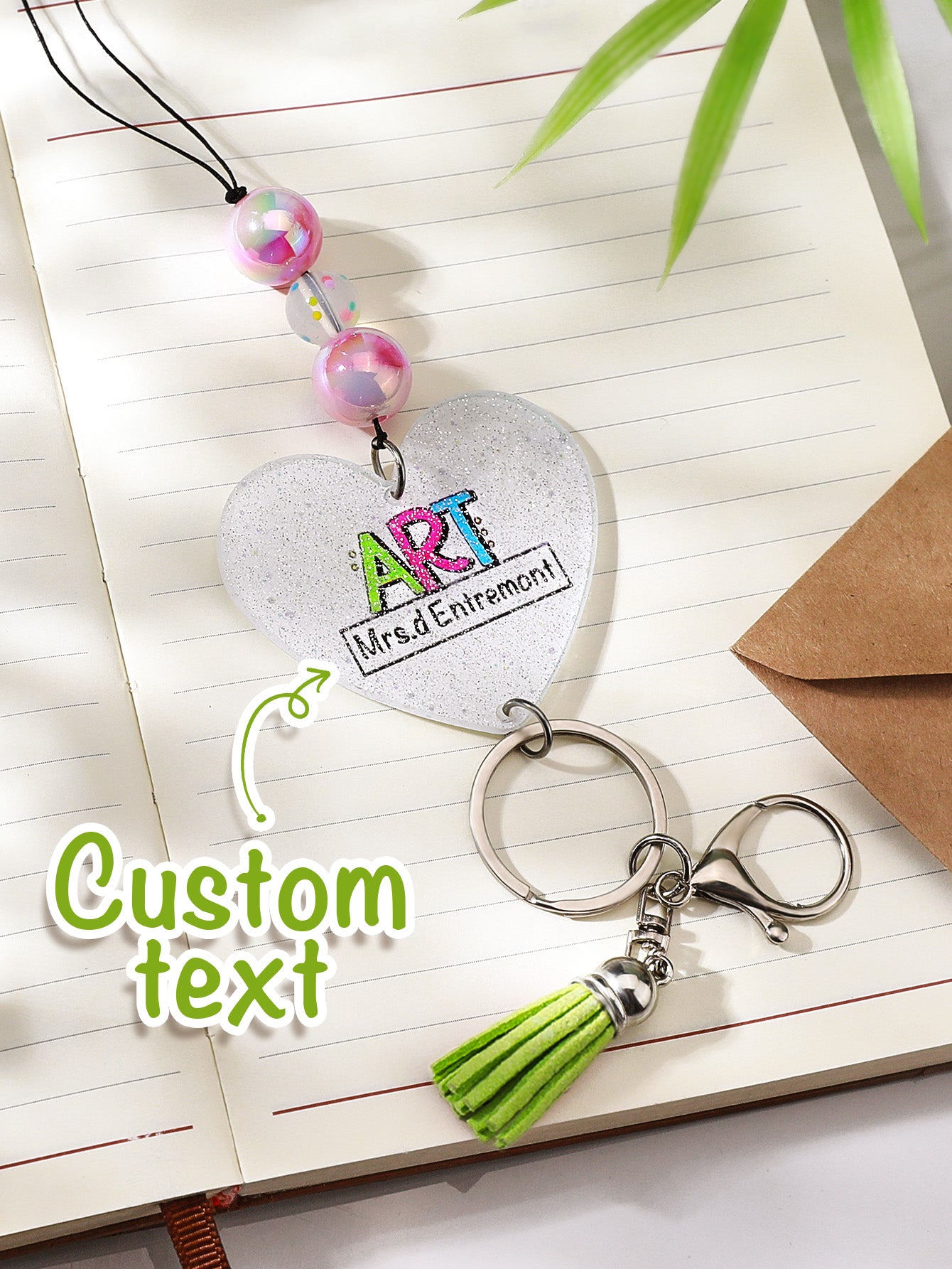 Macro of personalised lettering on acrylic name bead with sparkle background — custom teacher lanyard detail
