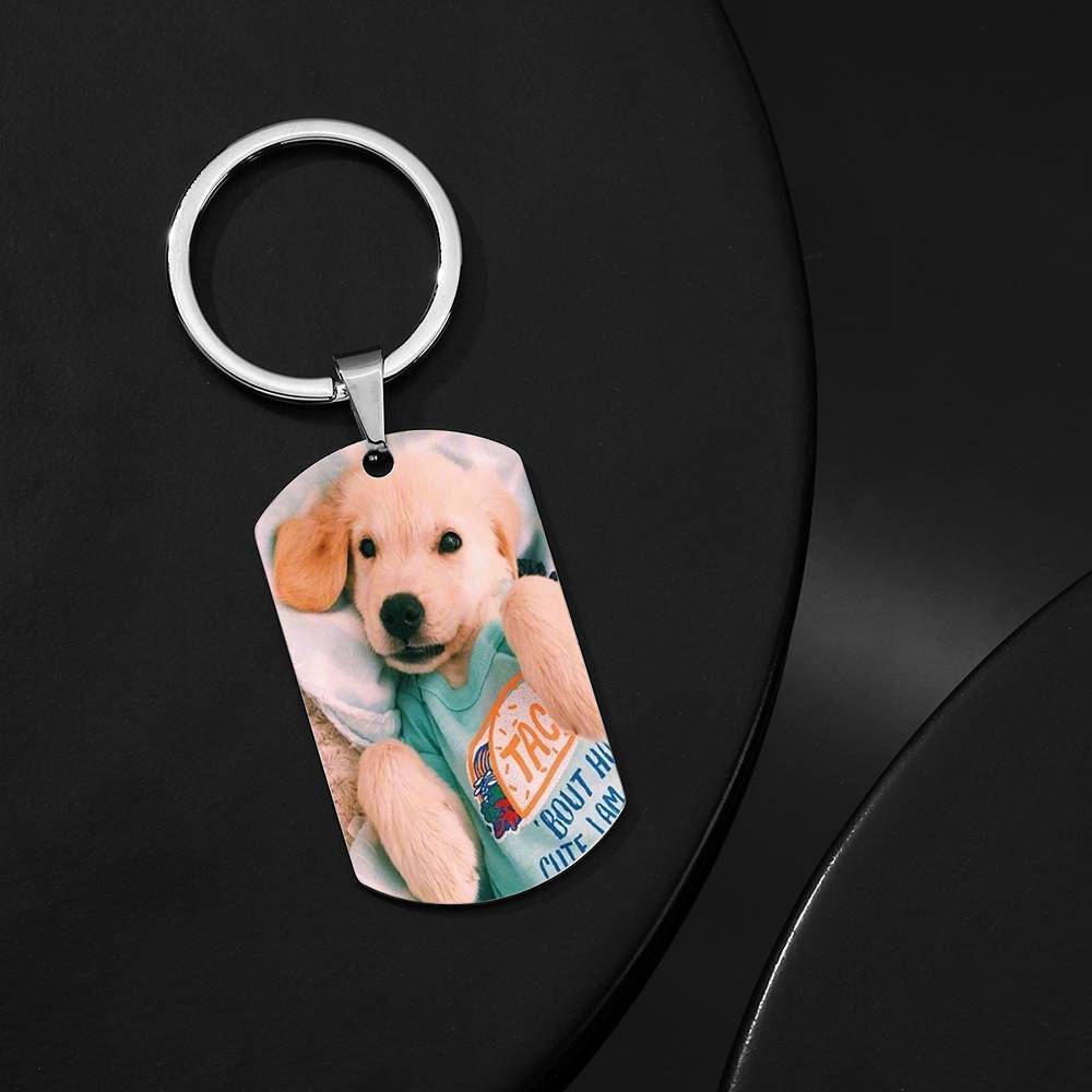 Personalised engraved stainless steel photo tag keychain attached to house keys and a leather bag, demonstrating practical use as a durable, sentimental keepsake